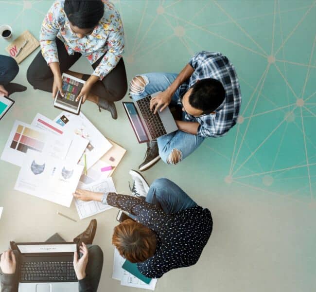 Group,of,diverse,people,collaborating,on,laptops,and,tablets.,teamwork